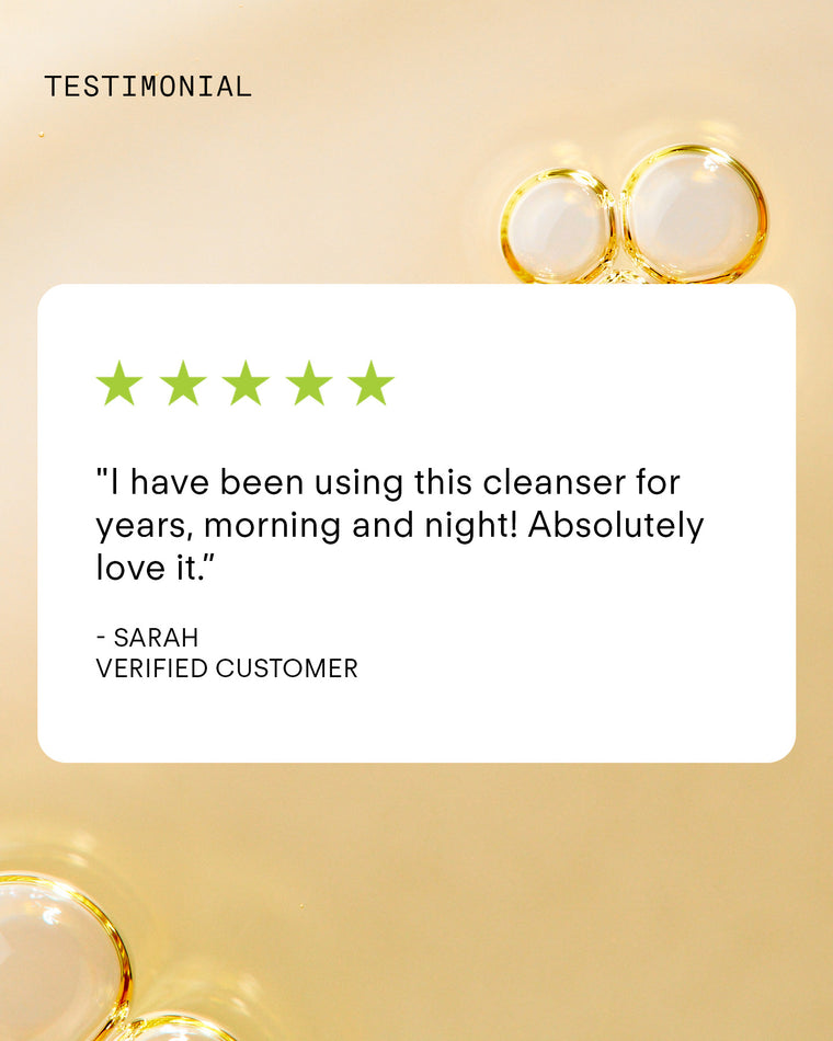A customer testimonial graphic with five green stars, a quote praising the Ultra Brightening Foaming Cleanser, and the name Sarah, Verified Customer on a light background with clear bubbles.