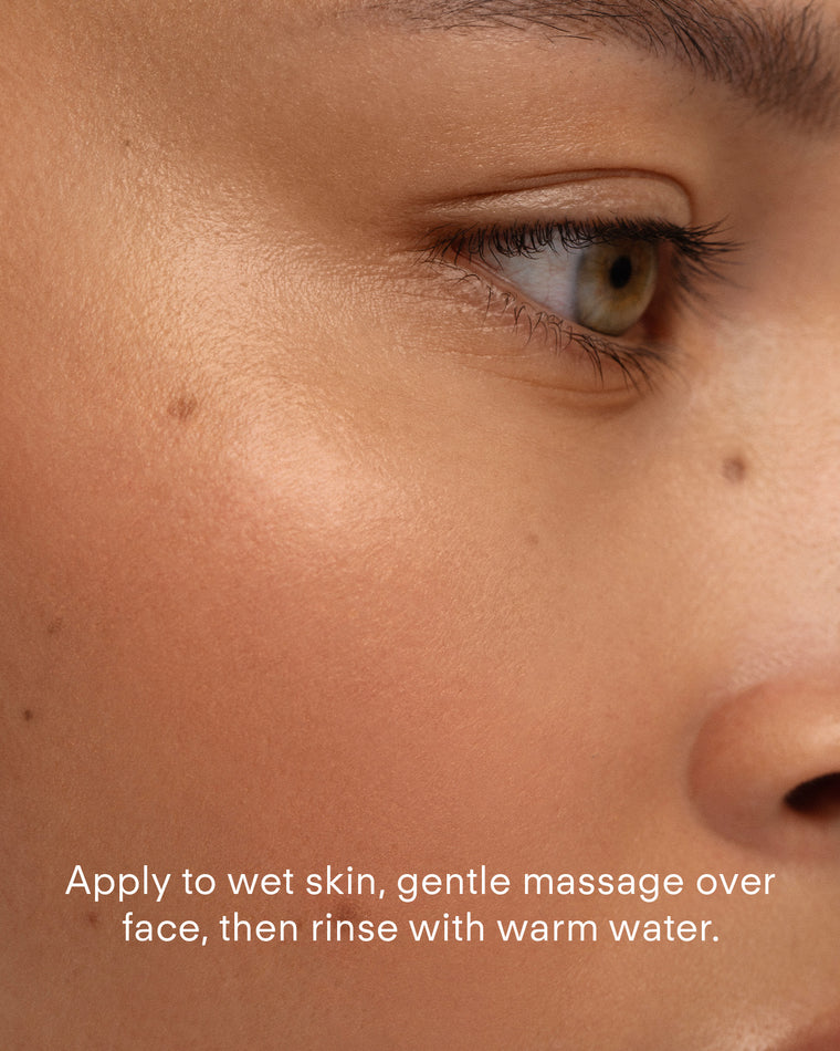 Close-up of a face with smooth skin, showing the eye, cheek, and nose. White text reads: Apply Ultra Clear Foaming Cleanser to wet skin, gently massage over face, then rinse with warm water.
