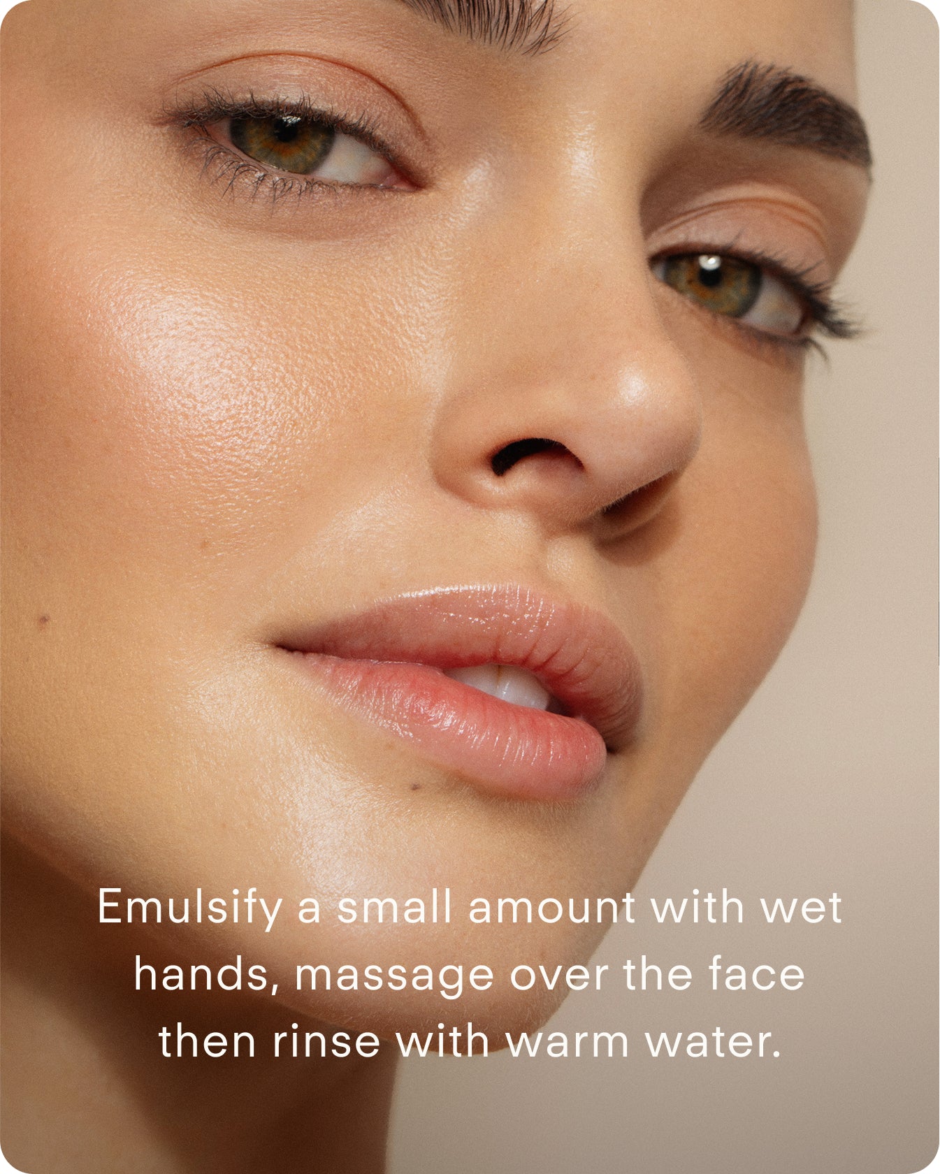 Close-up of a woman’s glowing, smooth skin with light makeup and natural brows. Text: Lumi Bright Foaming Facial Cleanser Mini – emulsify a small amount with wet hands, massage onto face, then rinse with warm water.