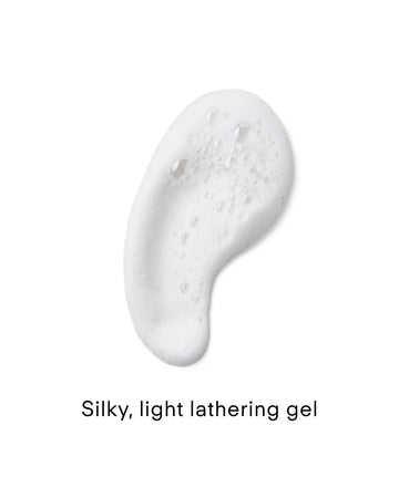 A dollop of white, bubbly gel on a white background. Text below reads: Lumi Bright Foaming Facial Cleanser 75ml—silky, light lathering gel.