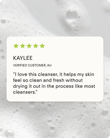 A five-star review says: I love B² Hydrating Balancing Gel Facial Cleanser—it leaves my skin clean and fresh without drying it out, unlike most cleansers. Background features white foamy bubbles.