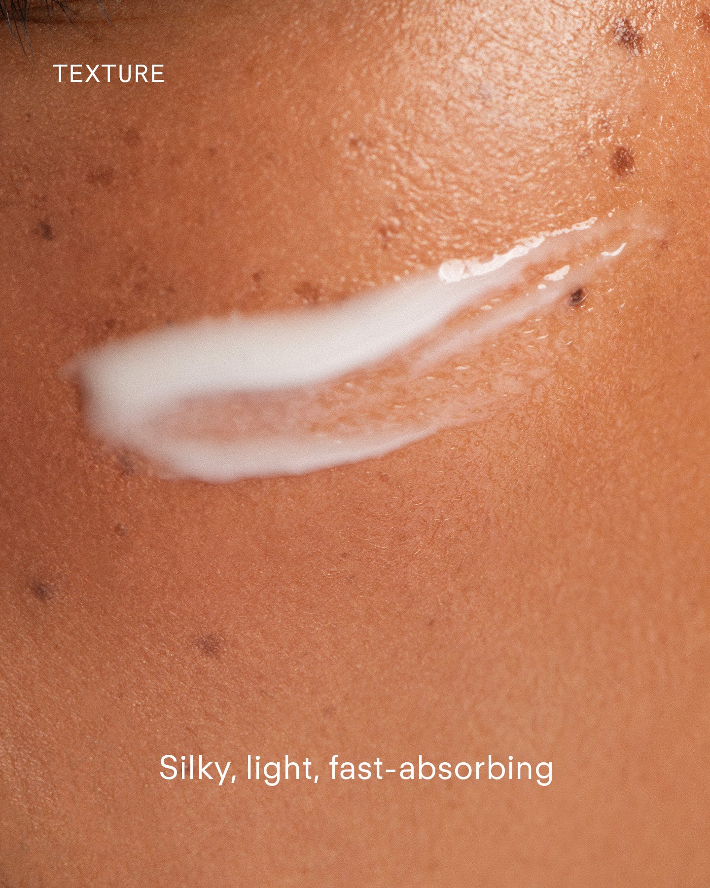 A close-up of a cheek with a swipe of white cream. “TEXTURE” at the top and “Ultra A Perfecting Serum Mild: Silky, light, fast-absorbing anti-aging formula” at the bottom.