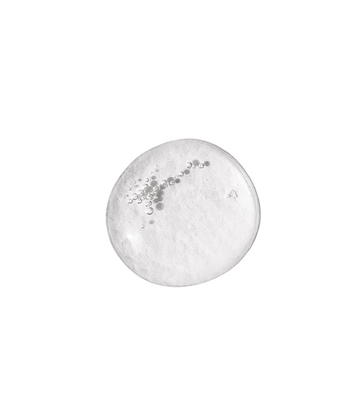 Even Skintone Smoothing Serum Mild appears as a clear, circular gel drop with tiny bubbles and niacinamide, displayed on a white background.