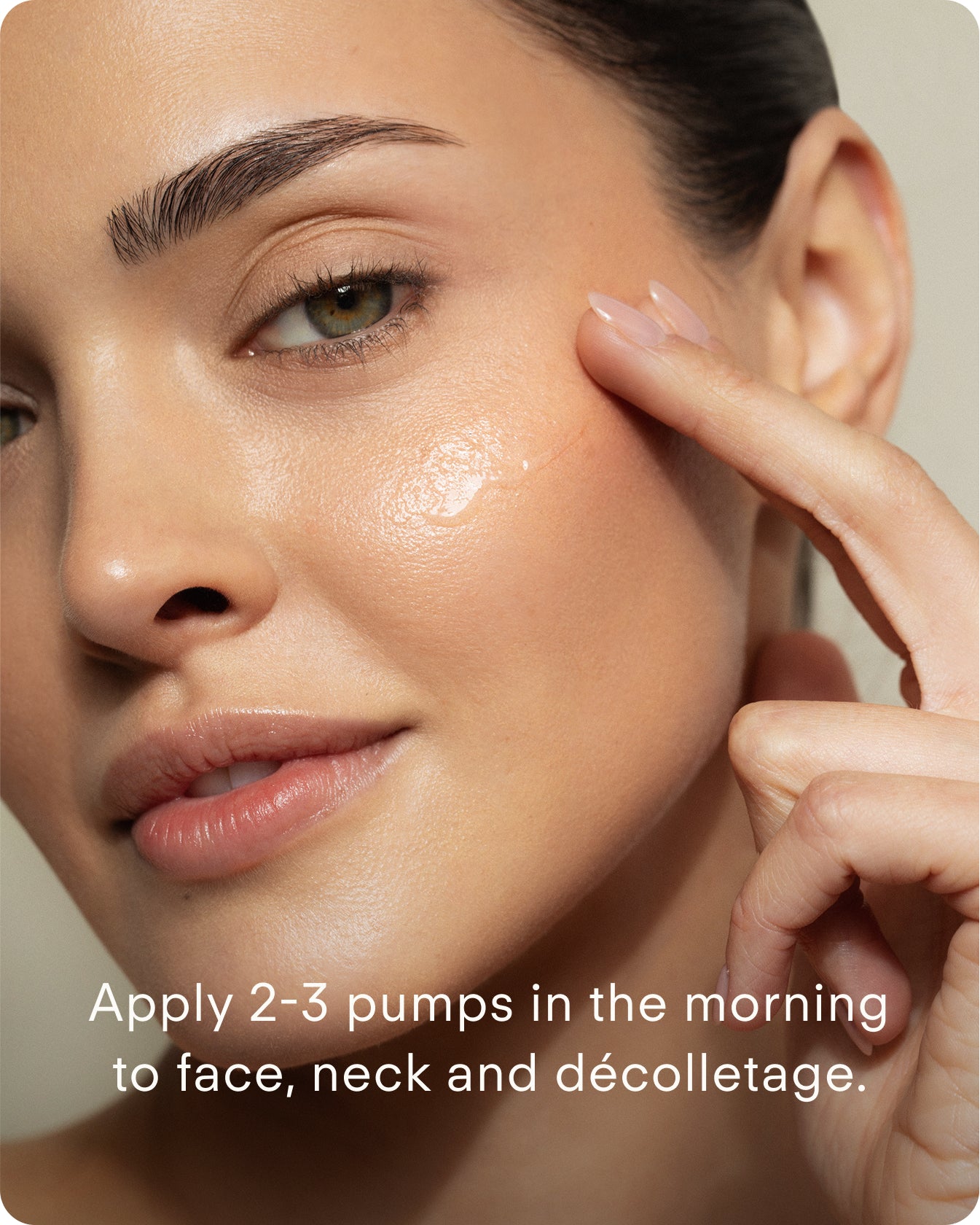A woman applies B² Hydrating HA 360 Facial Serum Supersize to her cheek, revealing glowing, healthy skin. Text on the image: Use 2-3 pumps each morning on face, neck, and décolletage.