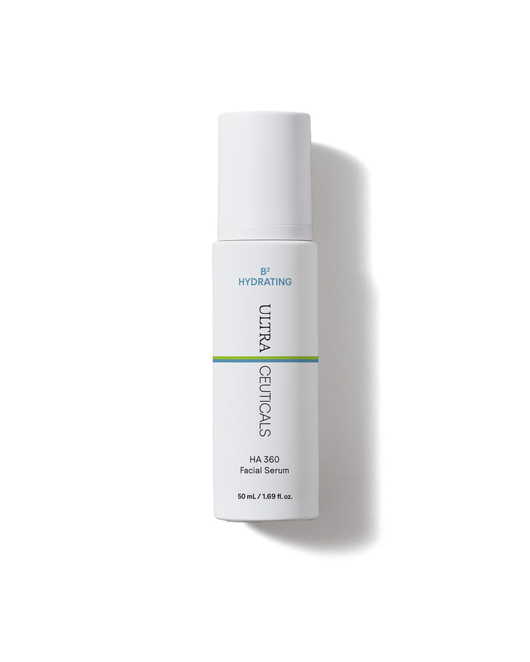 An upright white bottle of B² Hydrating HA 360 Facial Serum Supersize with a green stripe on a white background casts a soft shadow. The label says “Hydrating” and the bottle size is 50 mL (1.69 fl. oz.).