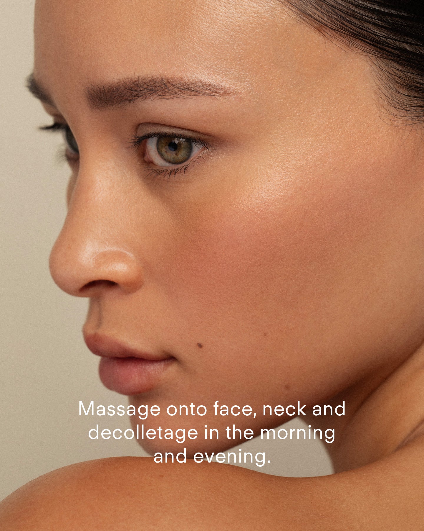 A close-up of a woman’s glowing skin. Text: Massage Ultra Hydrating Lotion onto face, neck, and decolletage morning and night to support your skin barrier.
