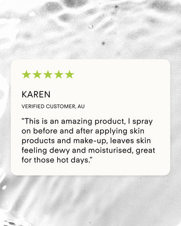 A 5-star review from verified customer Karen in Australia praised the Ultra Hydrating Skin Mist for keeping her skin dewy and moisturized on hot days. Displayed on a white card over a silver, water-like background.