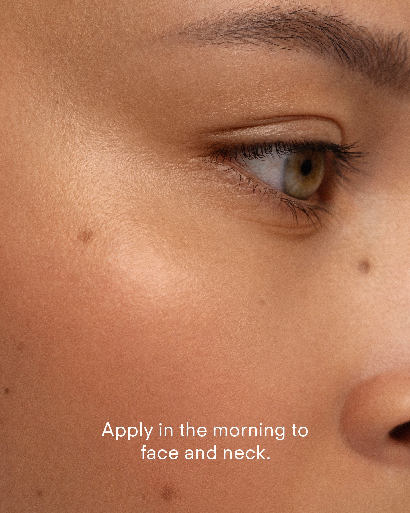 A close-up of a person’s eye and cheek with smooth skin. Text at the bottom: Apply Ultra Protective Antioxidant Complex each morning to face and neck for enhanced skin resilience against environmental stressors.