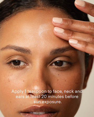 A person with oily skin applies Ultra UV Protective Daily Moisturiser SPF 50 Mattifying to their forehead, using 1 teaspoon for face, neck, and ears at least 20 minutes before sun exposure for a matte finish.