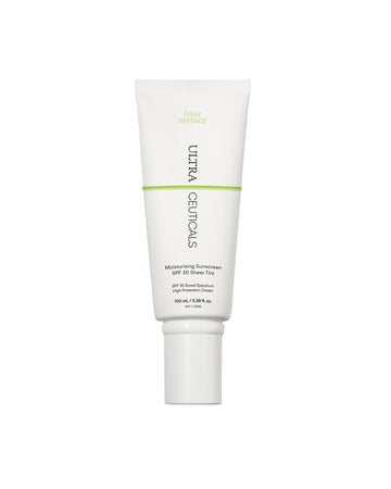 A white tube of Ultra UV Protective Daily SPF30 Sheer Tint, 100 ml, with green and black text stands upright on a white background. This broad-spectrum sunscreen provides daily hydrating protection for the skin.