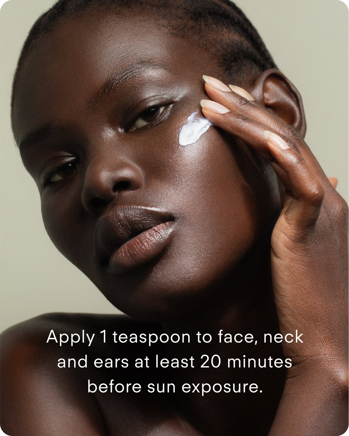 A woman with dark skin applies Ultra UV Protective Daily SPF50 Hydrating to her cheek. The text reads: Apply 1 teaspoon to face, neck, and ears at least 20 minutes before sun exposure.